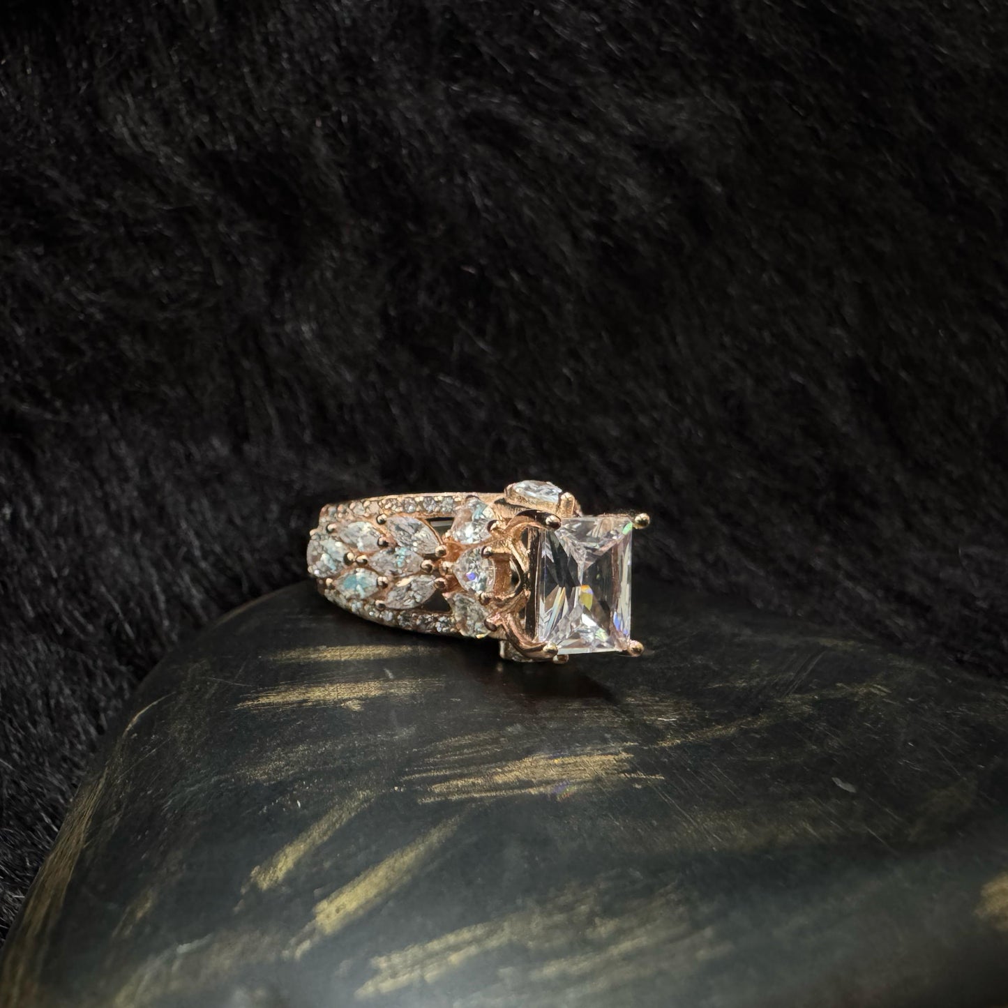 Elegant rose gold-plated 925 silver ring with a raised radiant-cut center stone and teardrop zirconia accents