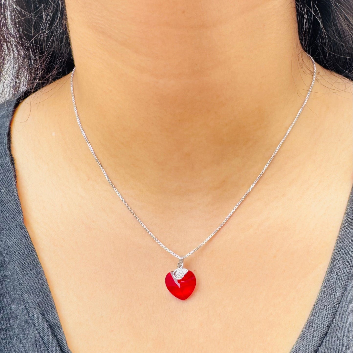 Our flaming heart necklace on a model