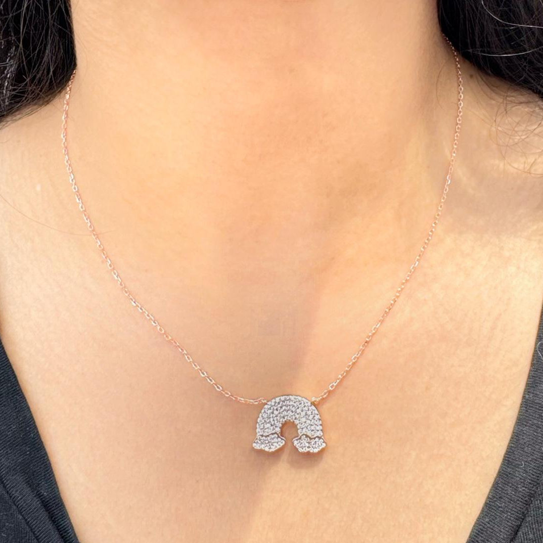 Radiant Arch necklace with a sparkling arch-shaped pendant, featuring Cubic Zirconia stones, and a delicate rose-gold chain.
