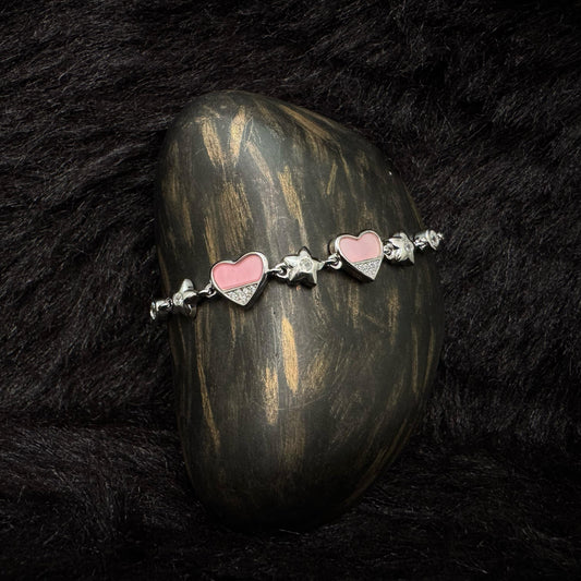 Sterling silver bracelet with pink enamel heart charms and zircon-studded details