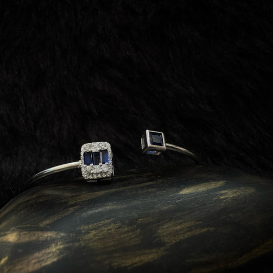 Sterling silver open cuff bracelet with rectangular and square deep blue stones set in zircon-studded and bezel settings