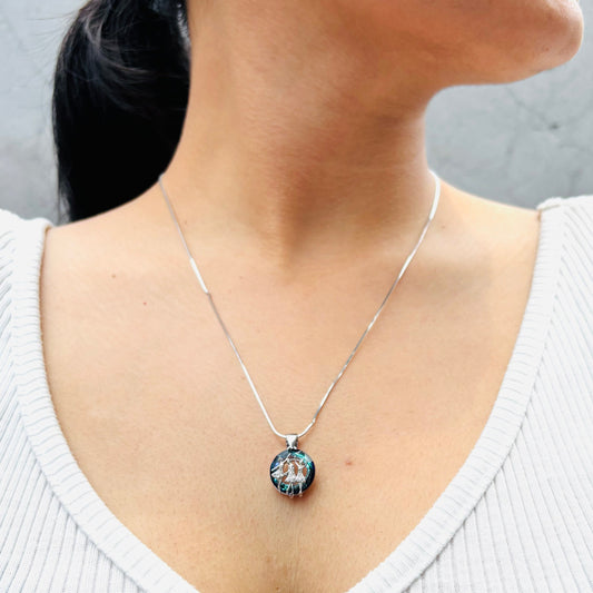 Our circle of life necklace on a model