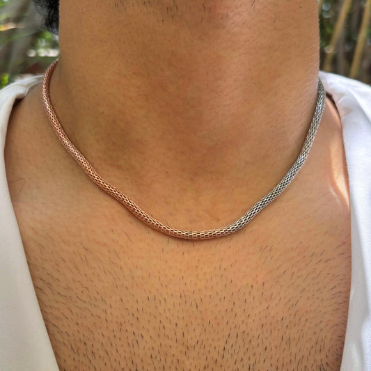 A dual-tone mesh necklace made of sterling silver and rose gold.