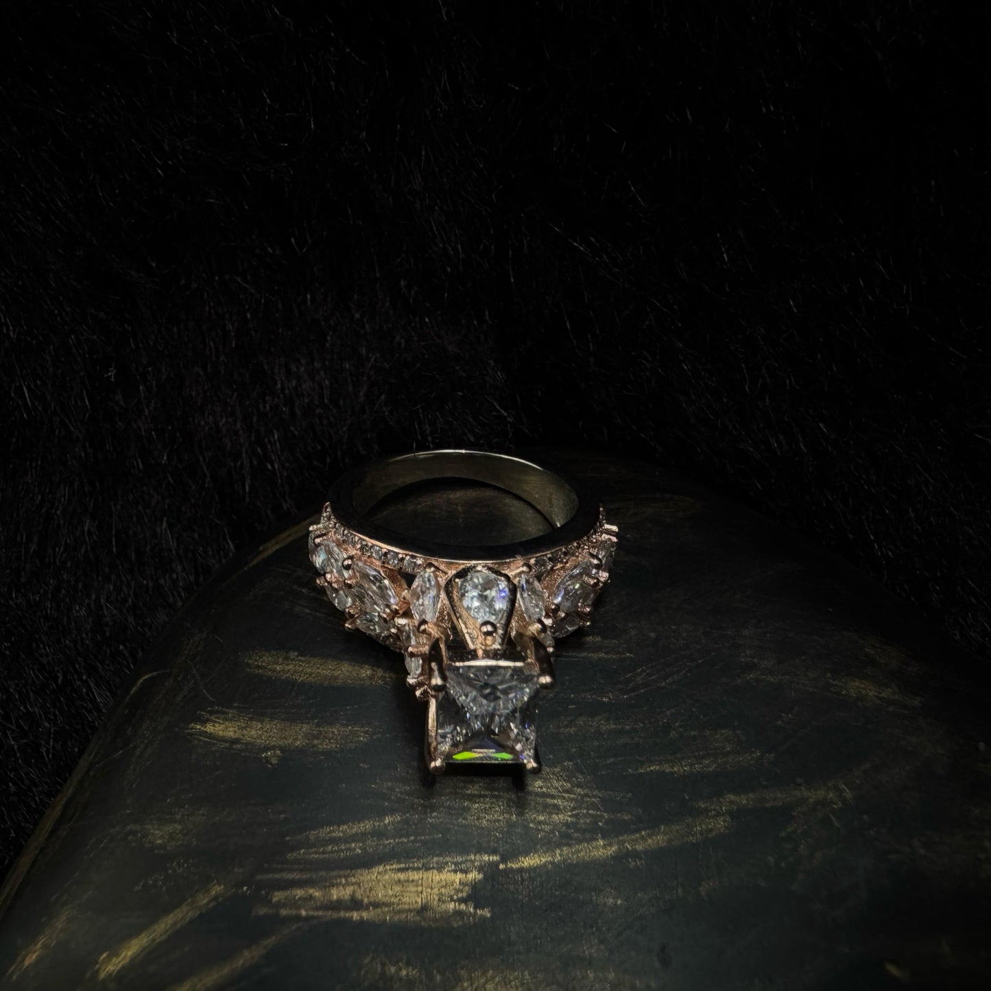 Elegant rose gold-plated 925 silver ring with a raised radiant-cut center stone and teardrop zirconia accents