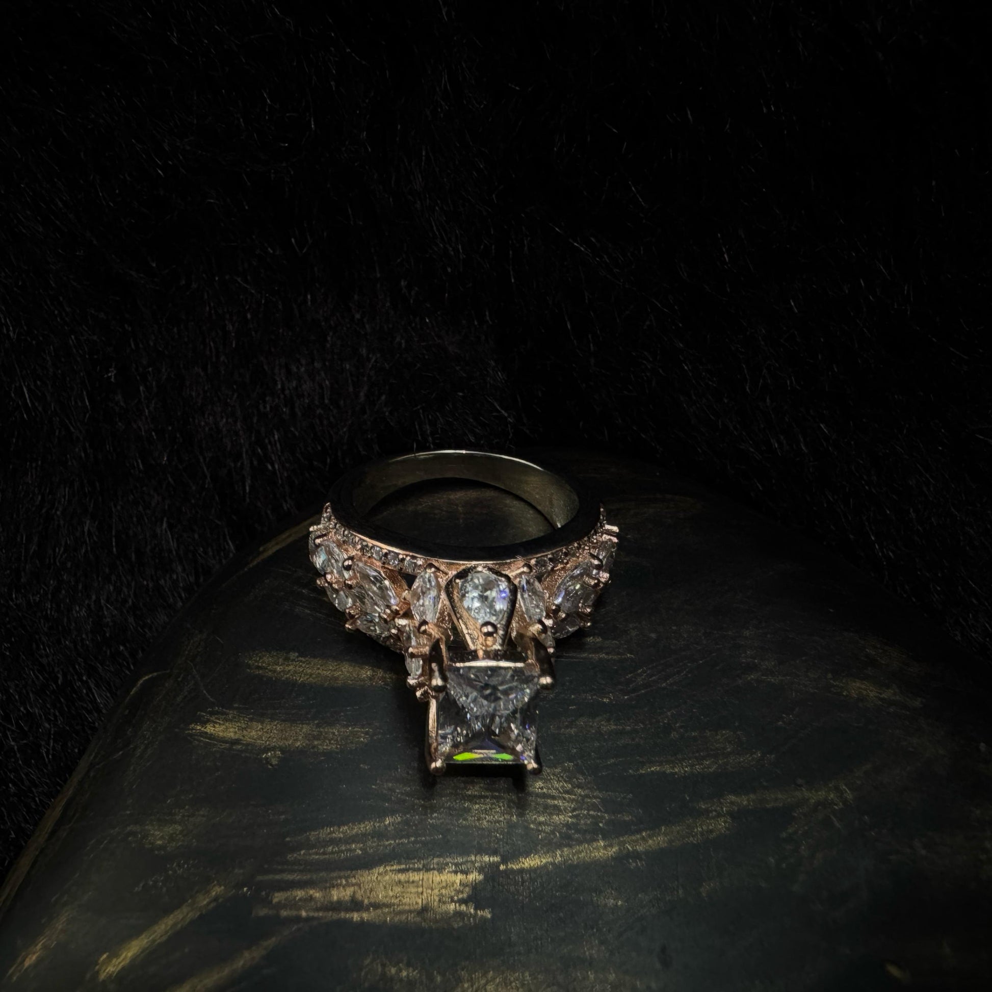 Elegant rose gold-plated 925 silver ring with a raised radiant-cut center stone and teardrop zirconia accents