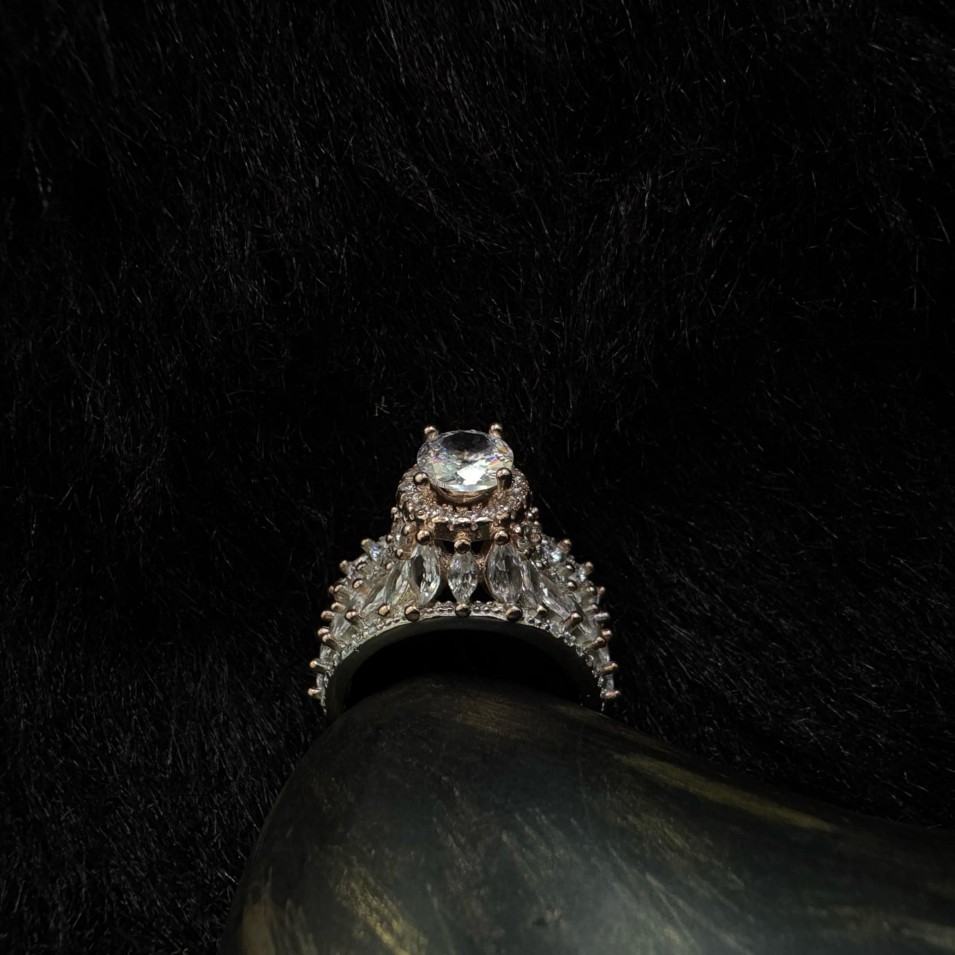 A luxurious 92.5 sterling silver crown ring with marquise and round-cut cubic zirconia stones, set against a dark background for a dramatic, regal look